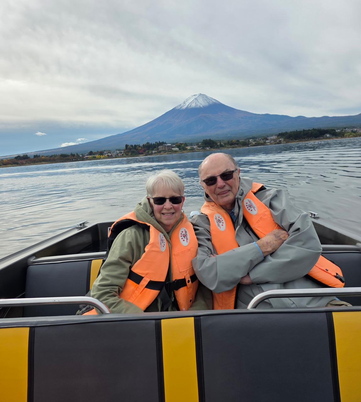 Carol and Jim from the United States on a boat on Lake Kawaguchi with Mount Fuji in the background