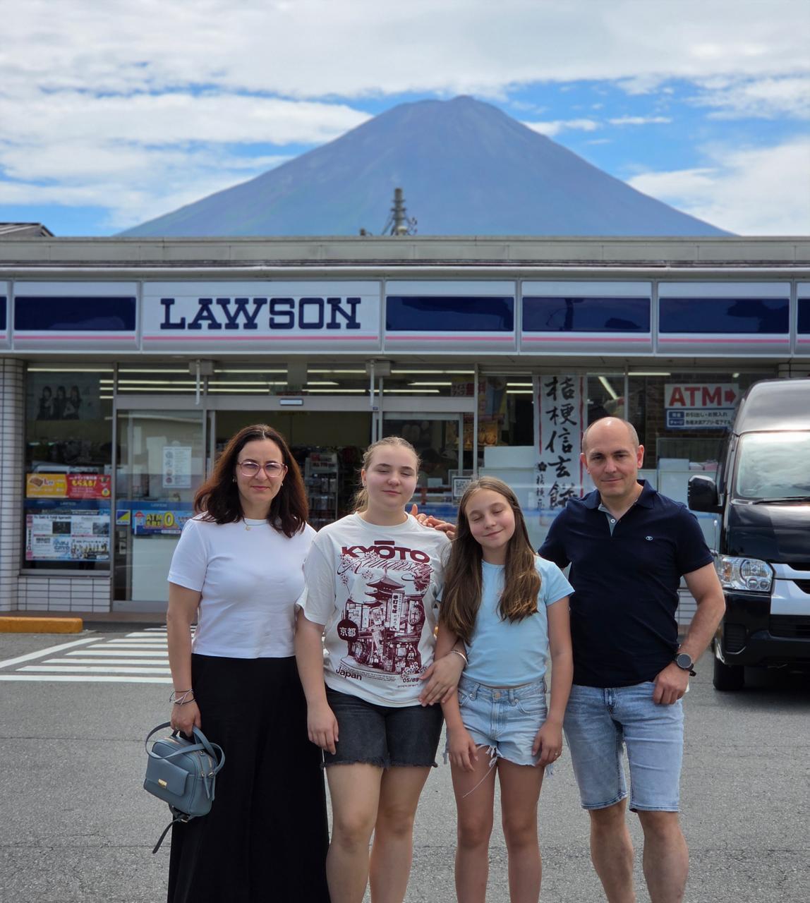 The Berg family from Denmark at the Lawson convenience store viewpoint with Mount Fuji behind